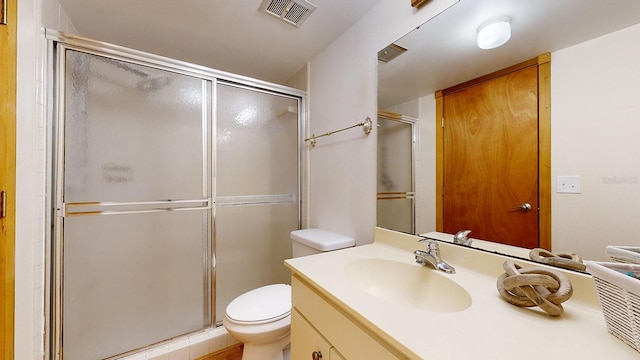 bathroom with vanity, walk in shower, and toilet