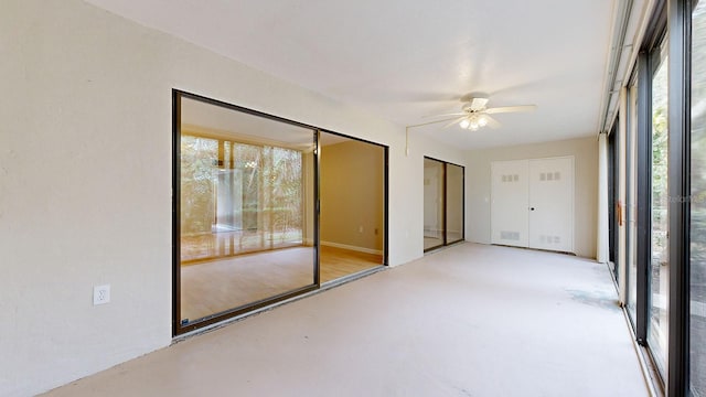 unfurnished sunroom with ceiling fan and a healthy amount of sunlight