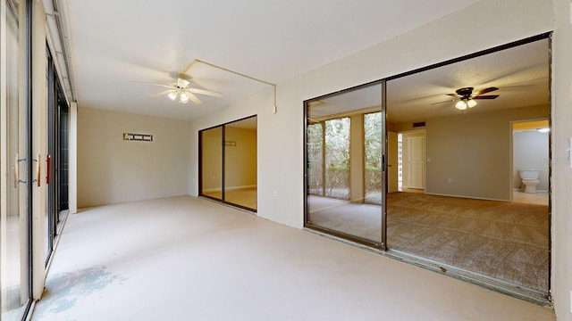 spare room with carpet and ceiling fan