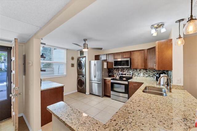 kitchen with decorative light fixtures, a healthy amount of sunlight, stainless steel appliances, and sink