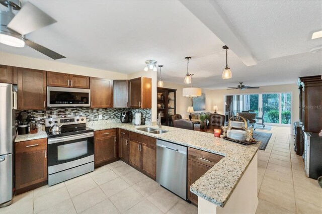 kitchen with sink, kitchen peninsula, stainless steel appliances, and ceiling fan