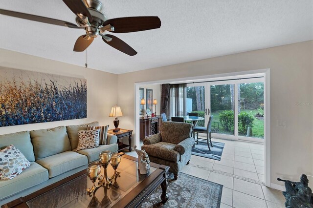 tiled living room with a textured ceiling and ceiling fan