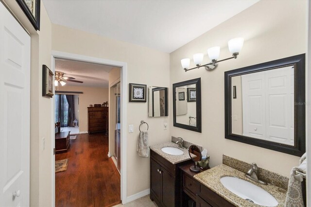 bathroom with ceiling fan, hardwood / wood-style flooring, and vanity