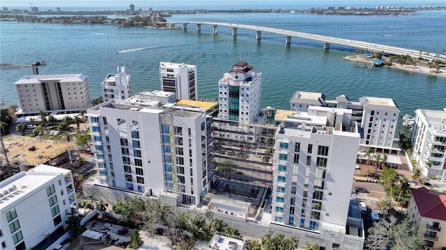 drone / aerial view featuring a view of city and a water view