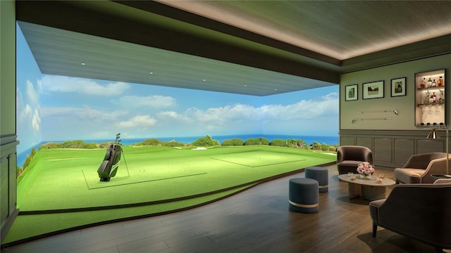 playroom with wood-type flooring, a water view, a wealth of natural light, and golf simulator