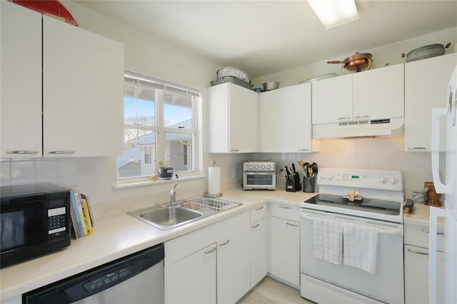 kitchen featuring sink, white appliances, white cabinets, and decorative backsplash