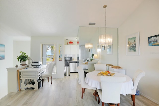 dining space with light wood-style floors, visible vents, a notable chandelier, and baseboards