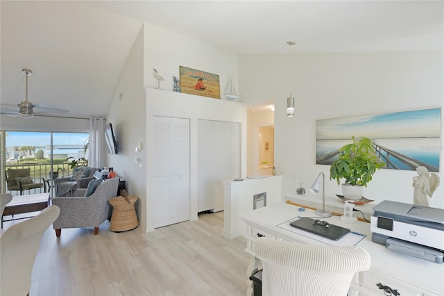 office with high vaulted ceiling, ceiling fan, and light hardwood / wood-style floors