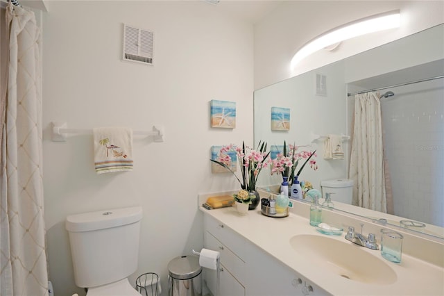 bathroom with a shower with shower curtain, toilet, and vanity