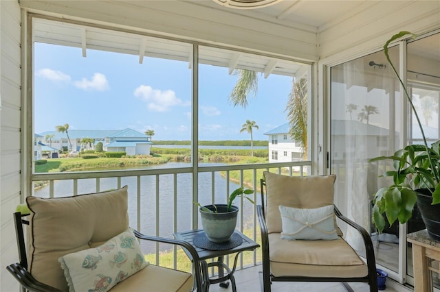 sunroom with a water view and plenty of natural light