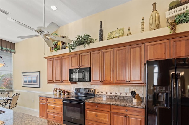 kitchen with ceiling fan, black appliances, decorative backsplash, and dark stone counters