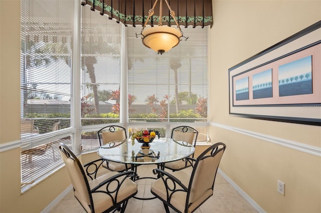 tiled dining room with a wealth of natural light