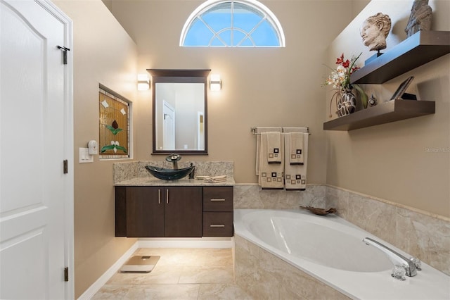 bathroom featuring tile patterned floors, vanity, lofted ceiling, and a relaxing tiled tub