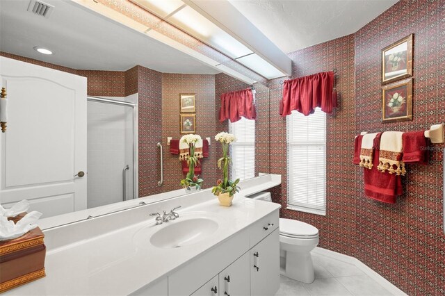 bathroom with vanity, toilet, and tile patterned flooring