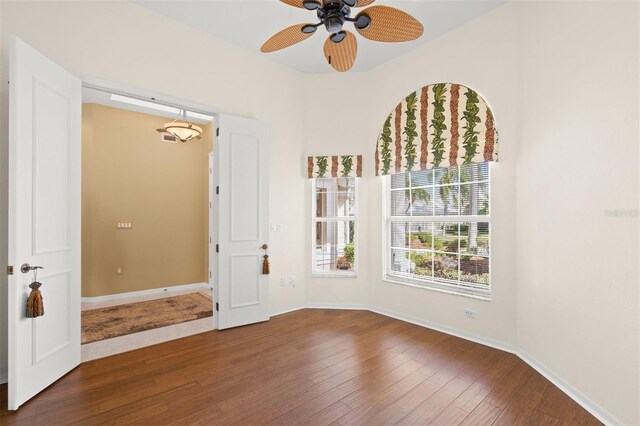 spare room with ceiling fan and wood-type flooring