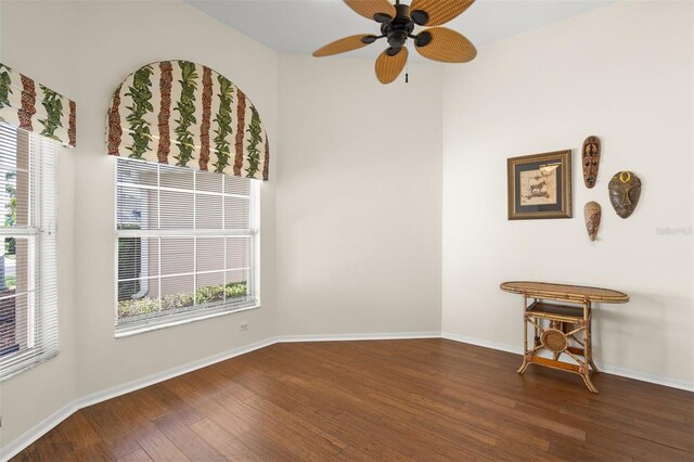 empty room featuring ceiling fan and dark wood-type flooring