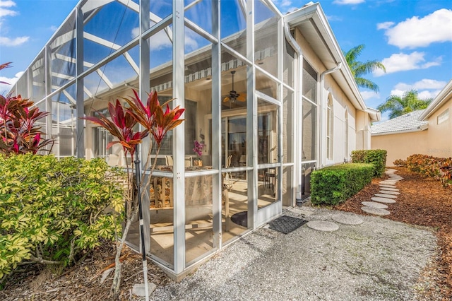 view of side of home featuring glass enclosure