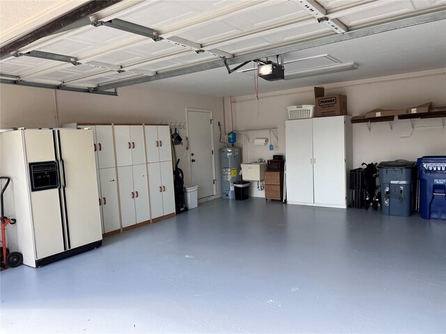 garage with water heater, sink, a garage door opener, and white fridge with ice dispenser