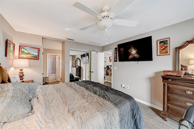 bedroom featuring a closet, a textured ceiling, dark carpet, and ceiling fan