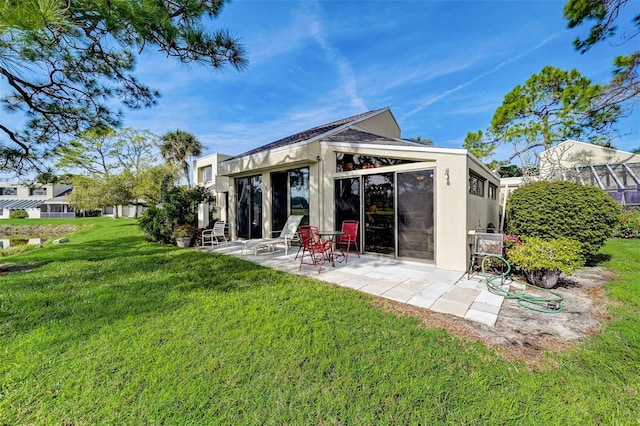 rear view of property with a patio area and a lawn