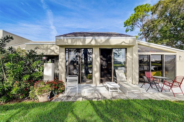 back of property with a patio