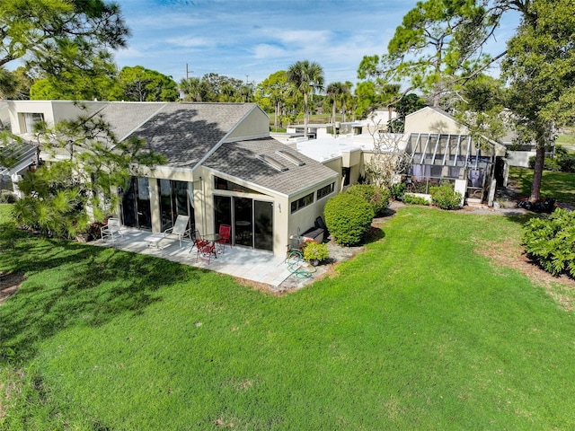 back of house featuring a yard and a patio