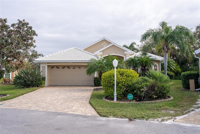 view of front of property featuring a garage and a front lawn