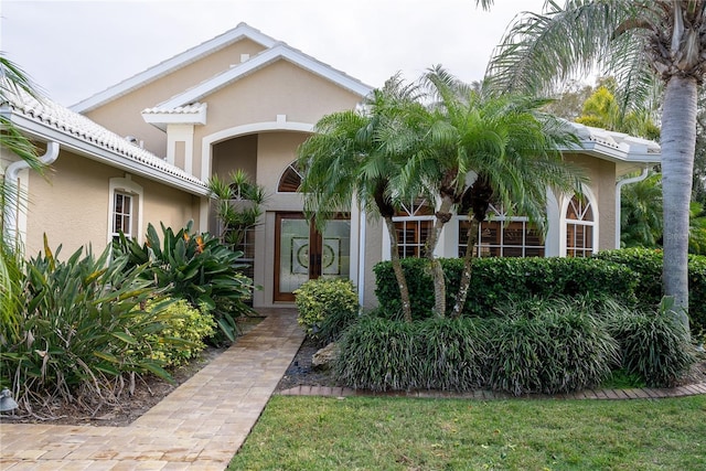 doorway to property with a lawn