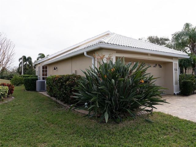 view of side of property with a yard and a garage