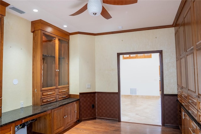 unfurnished office featuring crown molding, ceiling fan, and light wood-type flooring