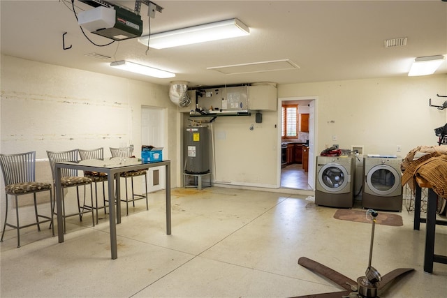 basement featuring washer and clothes dryer and electric water heater