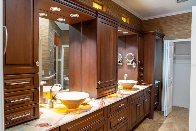 bathroom with ornamental molding and vanity