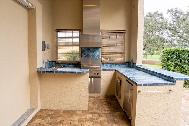 view of patio / terrace with an outdoor kitchen and sink