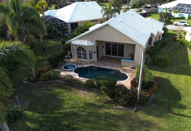 view of swimming pool featuring a yard, a patio, and an in ground hot tub