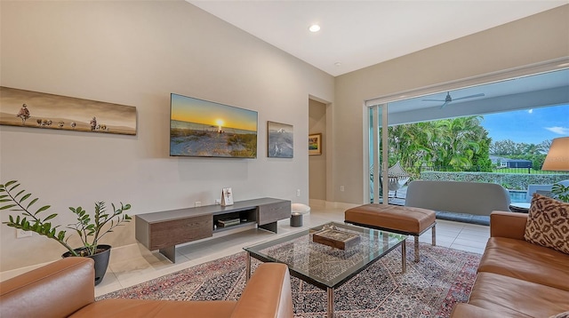 living room with light tile patterned floors, ceiling fan, and lofted ceiling