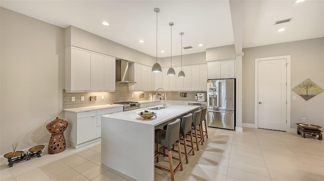 kitchen featuring white cabinetry, sink, wall chimney exhaust hood, and high end appliances