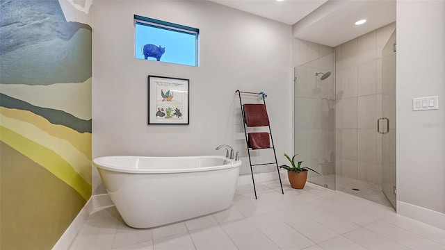 bathroom featuring tile patterned floors and separate shower and tub