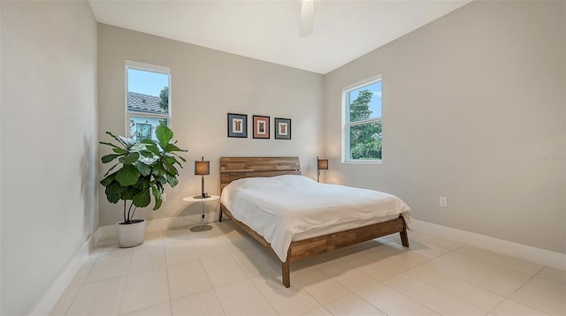 bedroom with light tile patterned flooring, multiple windows, and ceiling fan