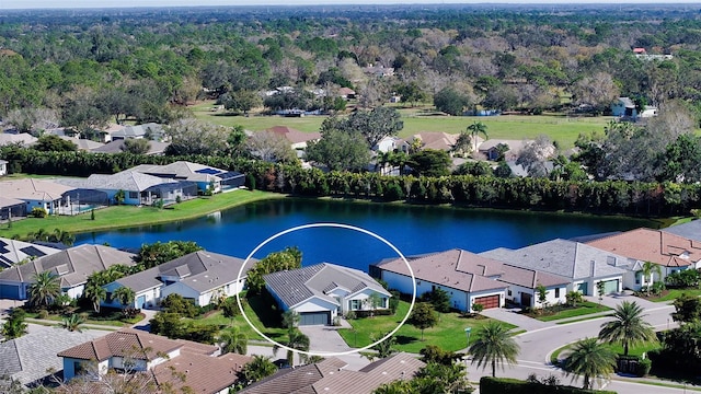 birds eye view of property with a water view