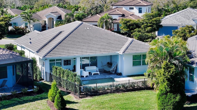 back of house with a lawn, a patio, and an outdoor hangout area