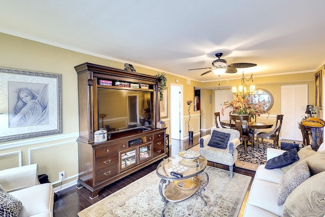 living room with ceiling fan with notable chandelier, dark hardwood / wood-style flooring, and ornamental molding