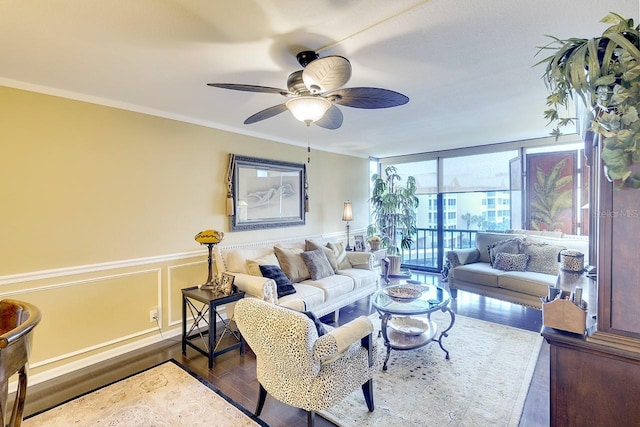 living room with ceiling fan, a wall of windows, dark wood-type flooring, and ornamental molding