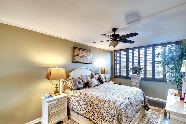 bedroom featuring ceiling fan, hardwood / wood-style flooring, and crown molding