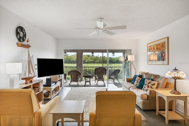 living room with a textured ceiling and ceiling fan