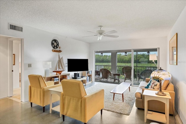 living room featuring a textured ceiling and ceiling fan