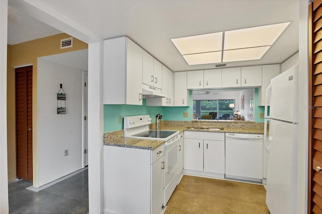 kitchen featuring white cabinets, custom range hood, light stone countertops, white appliances, and sink