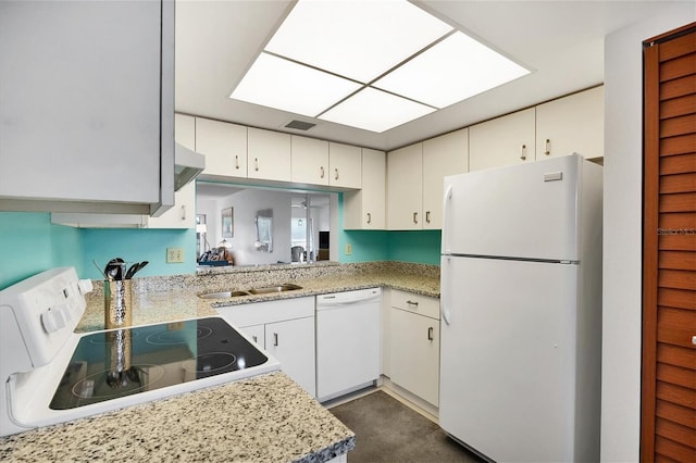 kitchen with sink, white appliances, light stone counters, and white cabinets