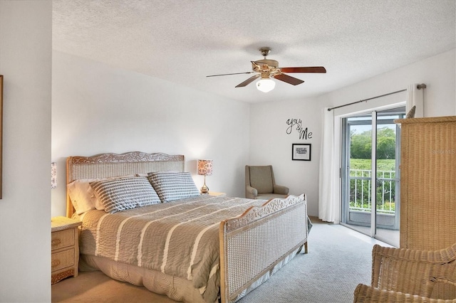 carpeted bedroom featuring access to exterior, ceiling fan, and a textured ceiling