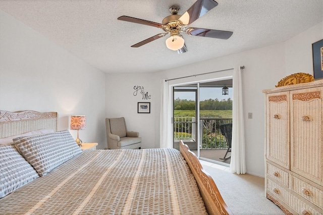 carpeted bedroom with a textured ceiling, ceiling fan, and access to outside