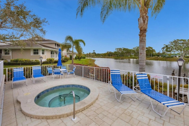 view of pool with a water view and a community hot tub